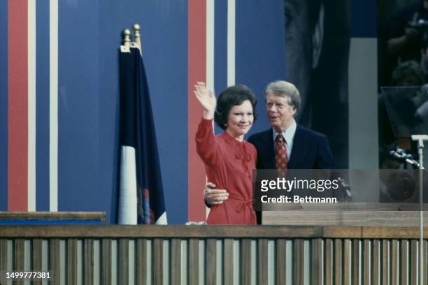 Democratic presidential candidate Jimmy Carter and his wife wave to delegates from the rostrum at the Democratic National Convention in Madison...