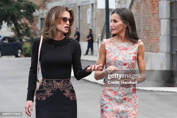 In this handout provided by the Spanish Royal Household, Queen Rania of Jordan and Queen Letizia of Spain arrive to visit the National Heritage...