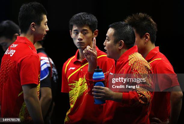 Coach Liu Guoliang of China talks with Ma Long of China about taking on Seungmin Ryu of Korea during the Men's Team Table Tennis gold medal match on...