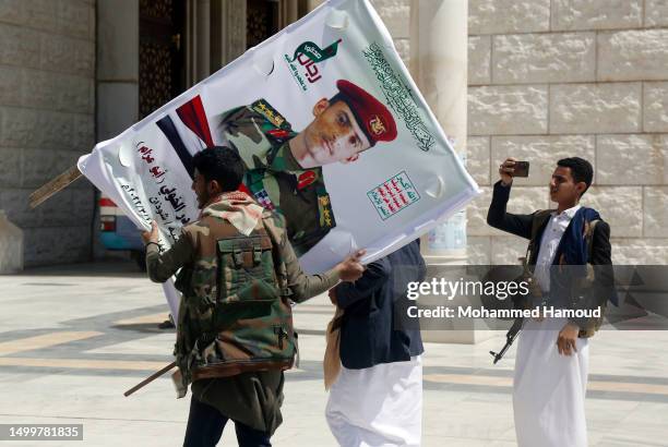 Mourner carries a banner of a Houthi fighter after he participated in a funeral at Al-Shaab mosque in Sanaa, Yemen on June 19, 2023. The Yemeni...