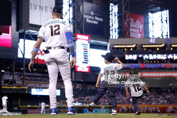 Lourdes Gurriel Jr. #12 of the Arizona Diamondbacks stands with his children before the game against the Cleveland Guardians at Chase Field on June...