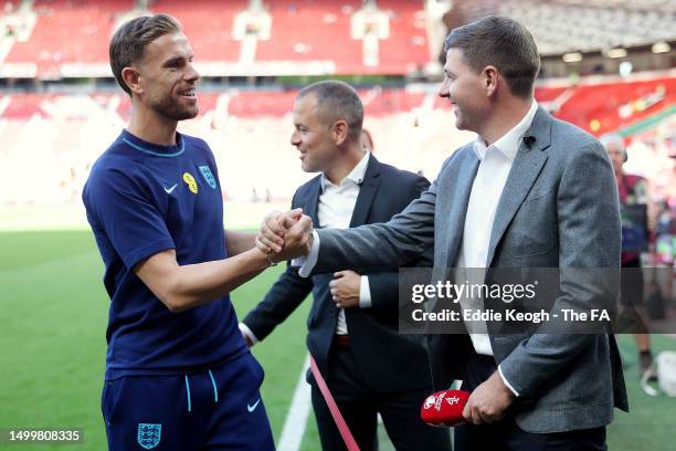 Jordan Henderson of England talks to former England player Steven Gerrard prior to the UEFA EURO 2024 qualifying round group C match between England...