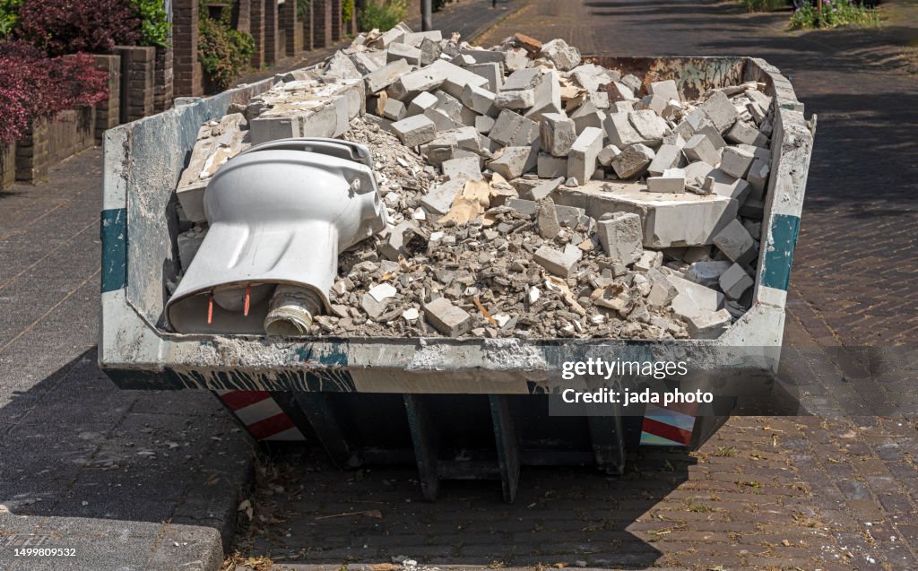 Front view of a open steel industrial waste container
