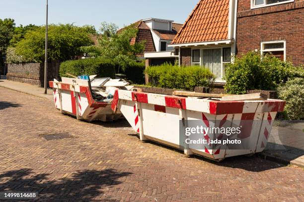 two open steel industrial waste containers filled with construction waste - waste skip stock pictures, royalty-free photos & images