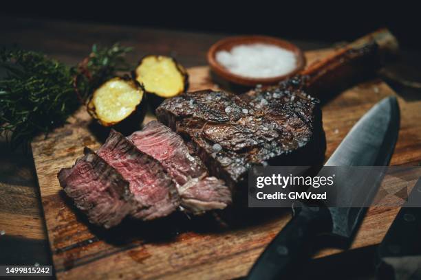 tomahawk steak with grilled potato - tomahawk stock pictures, royalty-free photos & images