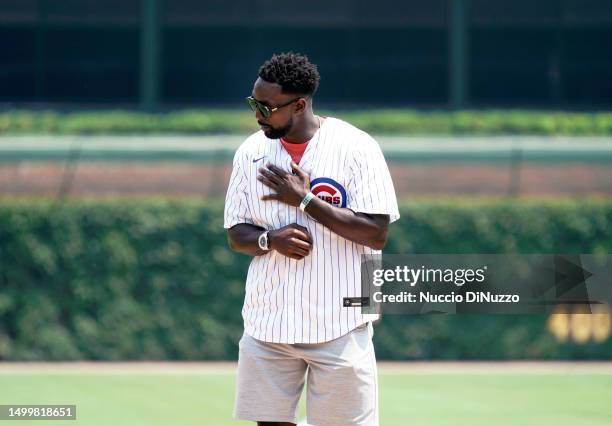 Retired Chicago Bears cornerback Charles "Peanut” Tillman throws the ceremonial first pitch of the game between the Chicago Cubs and the Baltimore...
