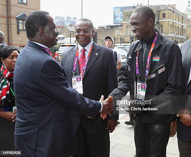 Prime Minister of Kenya, Raila Odinga greets athlete David Rudisha as he visits Kenya National House on August 8, 2012 in London, England.