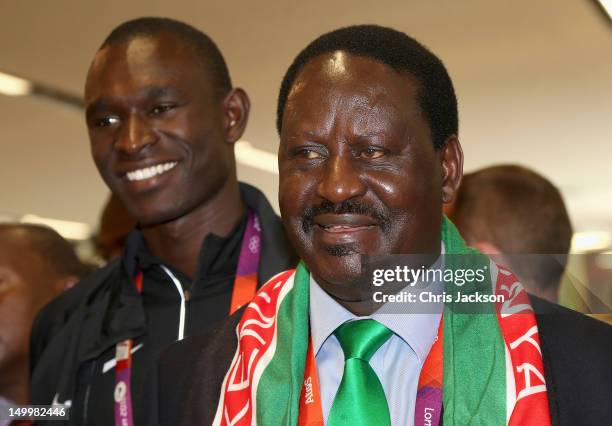 Prime Minister of Kenya, Raila Odinga smiles next to athlete David Rudisha as he visits Kenya National House on August 8, 2012 in London, England.