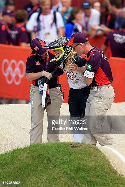 Brooke Crain of the United States is helped up after falling during the Women's BMX Cycling on Day 12 of the London 2012 Olympic Games at BMX Track...