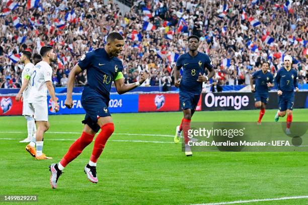 Kylian Mbappe of France celebrates after scoring the team's first goal from a penalty kick during the UEFA EURO 2024 qualifying round group B match...
