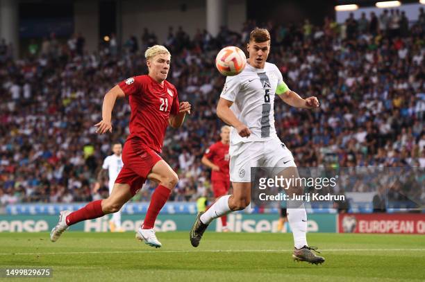 Rasmus Hojlund of Denmark and Jaka Bijol of Slovenia battle for possession during the UEFA EURO 2024 qualifying round group D match between Slovenia...
