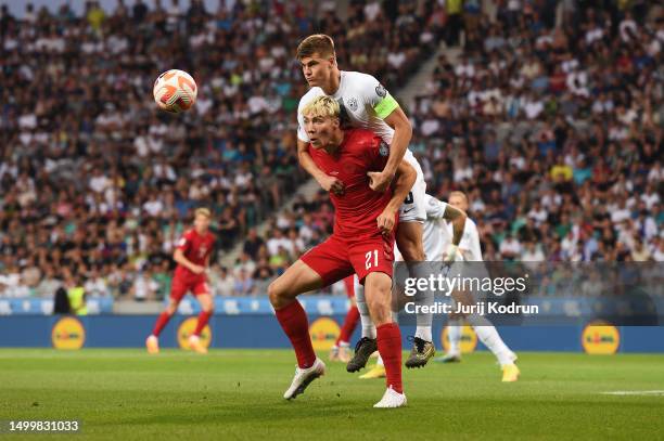 Rasmus Hojlund of Denmark and Jaka Bijol of Slovenia battle for possession during the UEFA EURO 2024 qualifying round group D match between Slovenia...