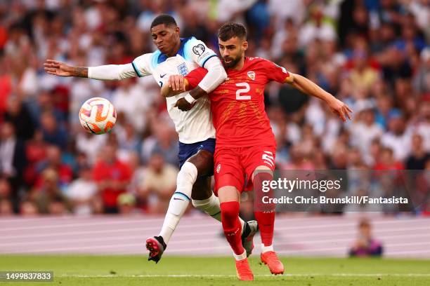 Marcus Rashford of England in action with Egzon Bejtulai of Macedonia during the UEFA EURO 2024 qualifying round group C match between England and...