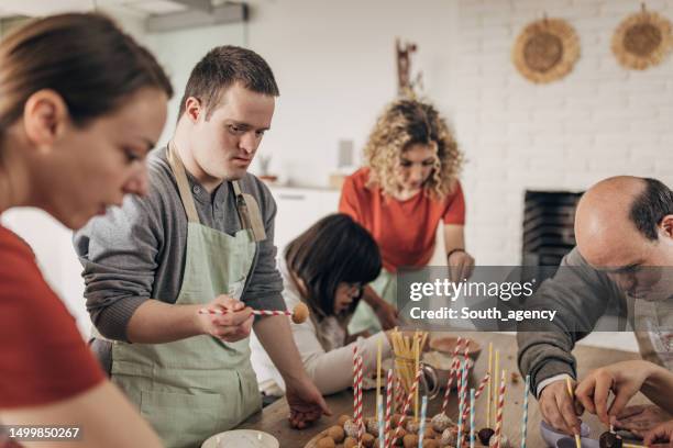 people making cookies on cooking class - cookery class stock pictures, royalty-free photos & images