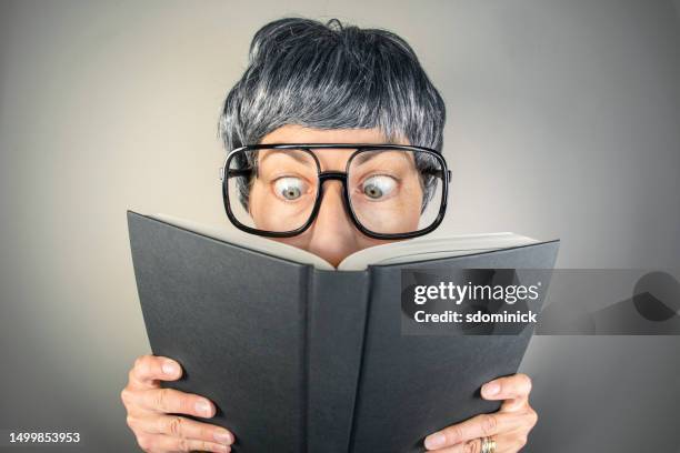 funny fisheye nerdy woman reading a book - ugly people stock pictures, royalty-free photos & images