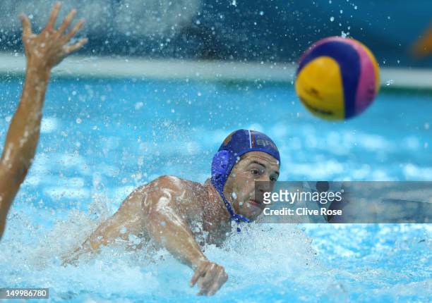 Vanja Udovicic of Serbia throws a pass in the Men's Water polo quarterfinal match between Australia and Serbia on Day 12 of the London 2012 Olympic...