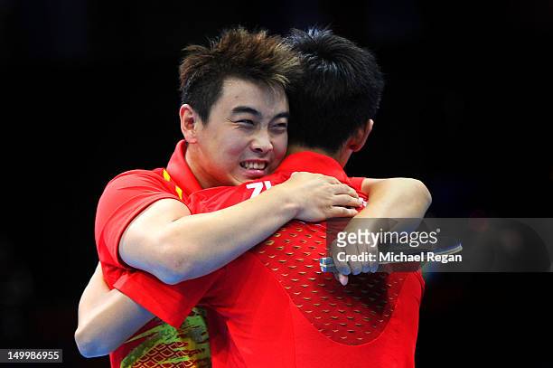 Wang Hao and Zhang Jike of China celebrate defeating Seungmin Ryu and Sang Eun Oh of Korea 3-0 and winning the Men's Team Table Tennis gold medal...