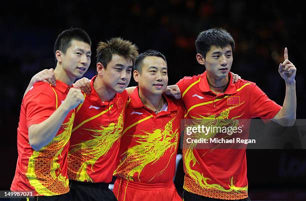 Ma Long, Wang Hao, Coach Liu Guoliang and Zhang Jike of China celebrate defeating Korea to win the Men's Team Table Tennis gold medal match on Day 12...