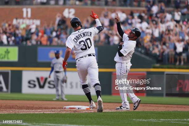 Kerry Carpenter of the Detroit Tigers celebrates his three run home run in the seventh inning with first base coach Alfredo Amezaga while playing the...