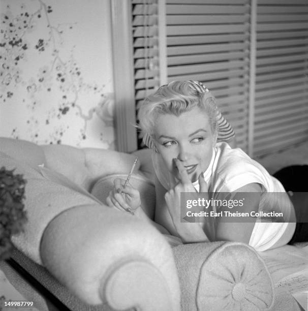 Marilyn Monroe poses for a portrait in her 20th Century-Fox dressing room on November 8, 1952 in Los Angeles, California.