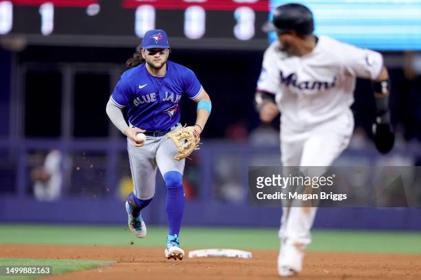 Bo Bichette of the Toronto Blue Jays runs down Luis Arraez of the Miami Marlins for an out in the sixth inning at loanDepot park on June 19, 2023 in...