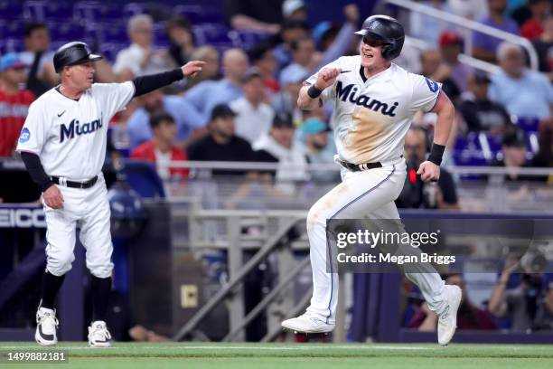 Garrett Cooper of the Miami Marlins runs home to score on a single off the bat of Jon Berti against the Toronto Blue Jays in the seventh inning at...