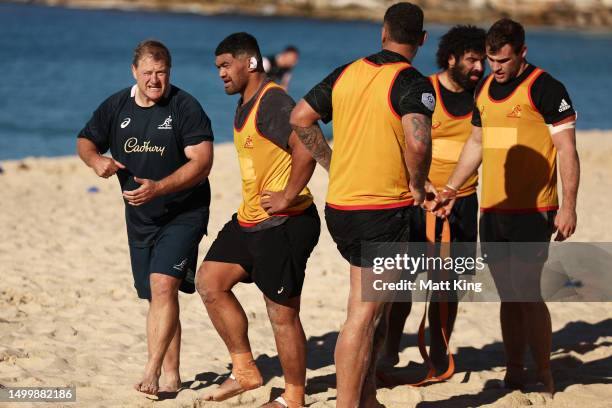 Wallabies assistant coach Neal Hatley talks to Jordan Uelese during an Australian Wallabies training session at Coogee Beach on June 20, 2023 in...