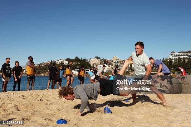 James Tuttle and Ned Hanigan take part in a drill during an Australian Wallabies training session at Coogee Beach on June 20, 2023 in Sydney,...