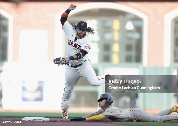 Ha-Seong Kim of the San Diego Padres safely steals second base as Brandon Crawford of the San Francisco Giants attempts to field the ball in the top...