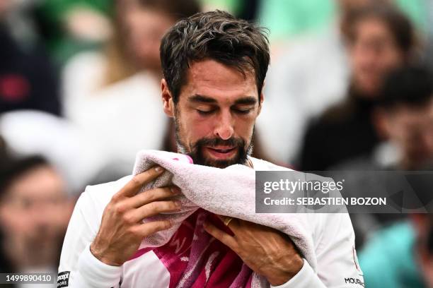 France's Jeremy Chardy uses a towel during a break in his men's singles tennis match against Spain's Carlos Alcaraz on the second day of the 2023...