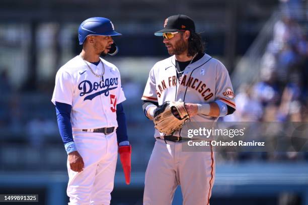 Mookie Betts of the Los Angeles Dodgers and Brandon Crawford of the San Francisco Giants talk during the ninth inning at Dodger Stadium on June 18,...