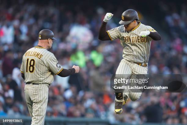 Juan Soto of the San Diego Padres celebrates with third base coach Matt Williams after hitting a solo home run in the top of the fifth inning against...