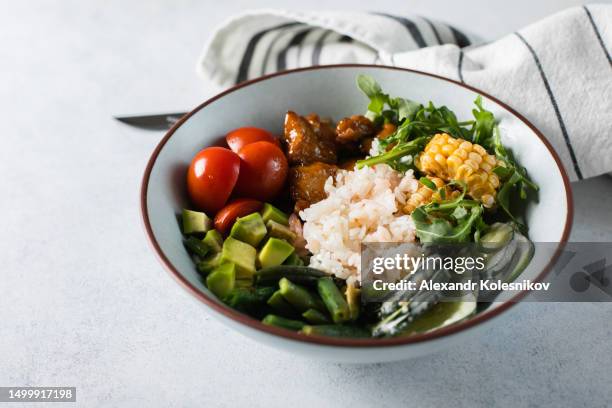 healthy lunch bowl. avocado, rice, tomato, cucumber, green beans, corn, arugula and chicken teriyakiin sweet and sour sauce. top view - course meal stock pictures, royalty-free photos & images