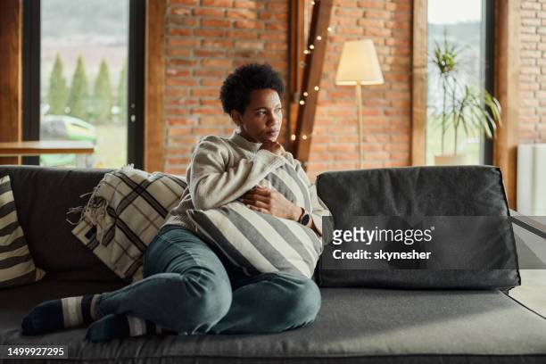 pensive african american woman relaxing at home. - pensive bildbanksfoton och bilder