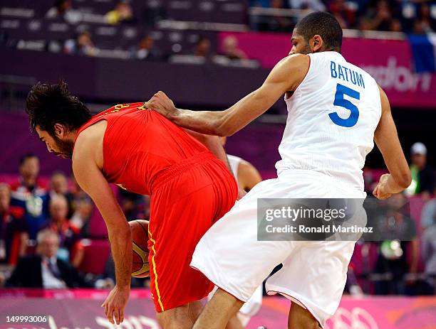 Nicolas Batum of France fouls Juan-Carlos Navarro of Spain late in the fourth quarter during the Men's Basketball quaterfinal game on Day 12 of the...