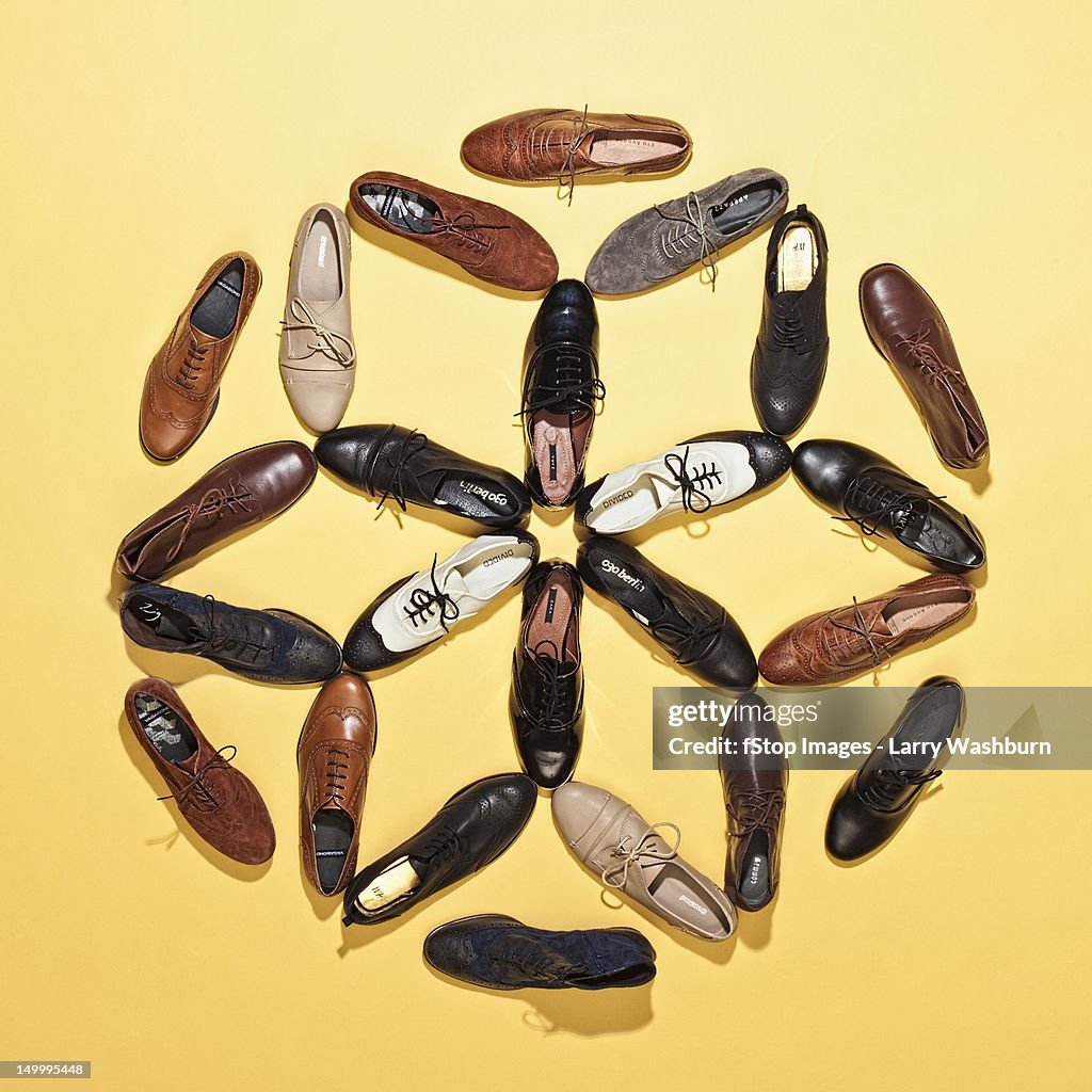 Various lace up shoes arranged in a pattern