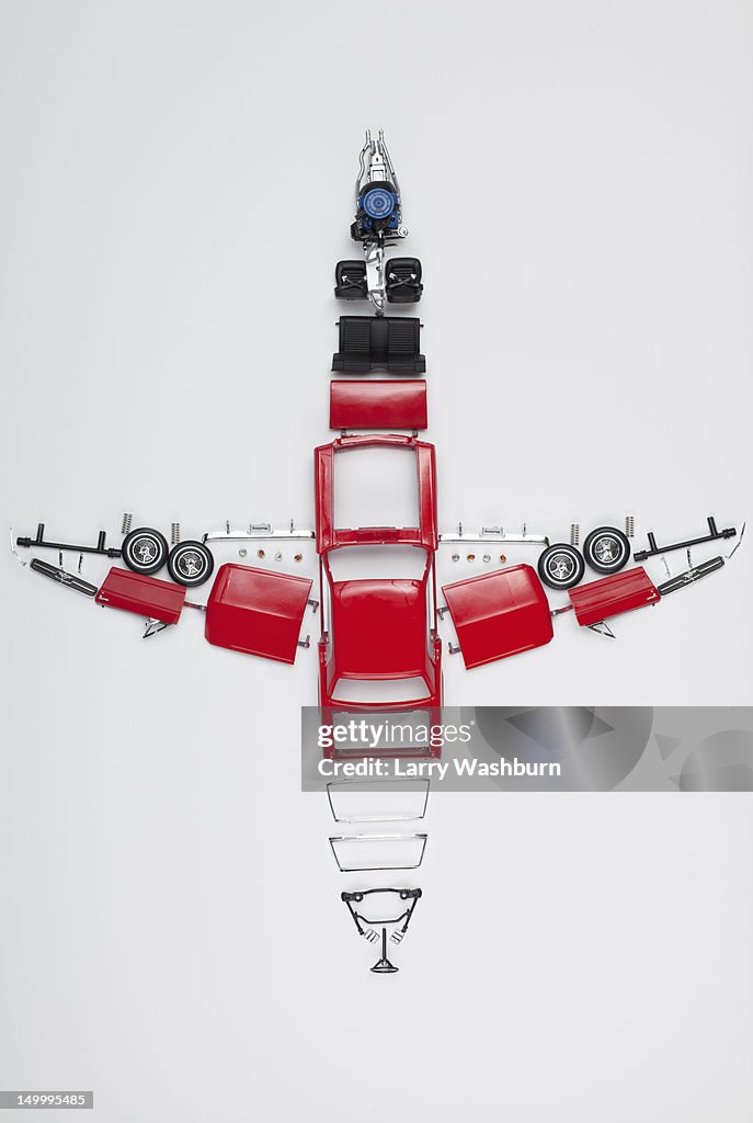 Parts of a model car arranged in the form of an airplane