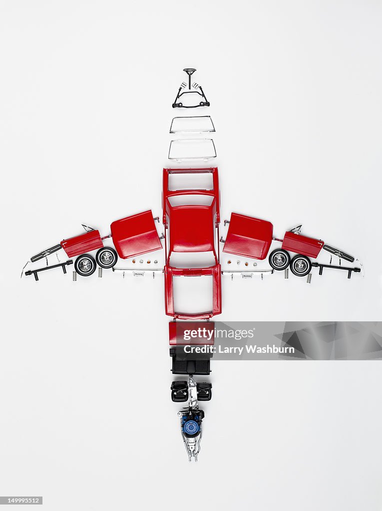 Parts of a model car arranged in the form of an airplane