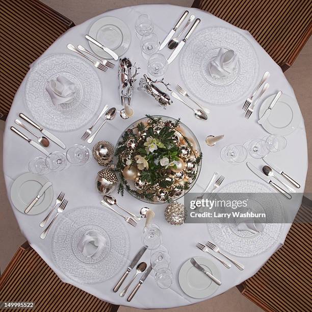 a table set for a formal dinner for four - black tie dinner stock-fotos und bilder