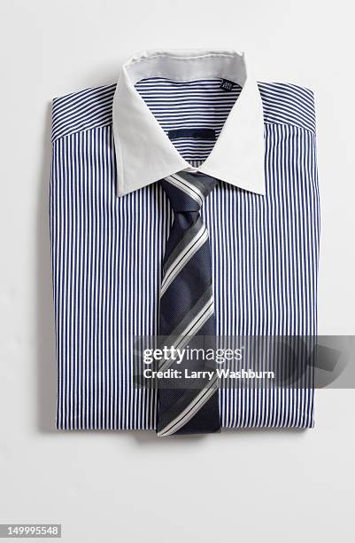 a folded shirt with a tie - striped shirt stock pictures, royalty-free photos & images