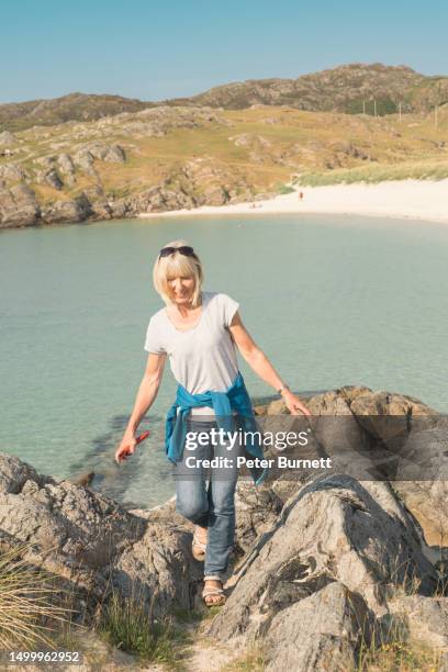 having fun above achmelvich beach, lochinver, scotland - achmelvich stock pictures, royalty-free photos & images