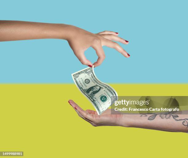 two women's hands people exchanging money - bizarre stock pictures, royalty-free photos & images