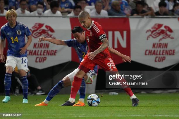 Paolo Guerrero of Peru and Yukinari Sugawara of Japan compete for the ball during the international friendly match between Japan and Peru at...