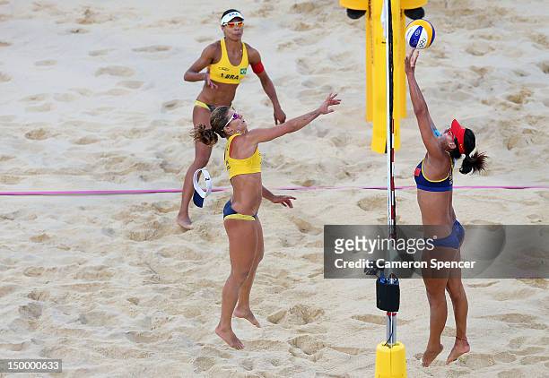 Chen Xue of China attempts to control the ball as Larissa Franca of Brazil defends in match point in the Women's Beach Volleyball Bronze medal match...