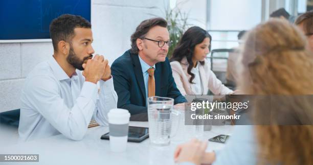 business people talking in boardroom - part of a series stock pictures, royalty-free photos & images
