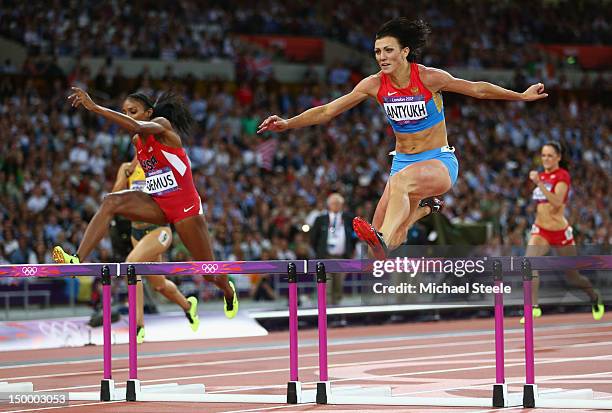 Natalya Antyukh of Russia crosses the finish line ahead of Lashinda Demus of the United States in the Women's 400m Hurdles Final on Day 12 of the...