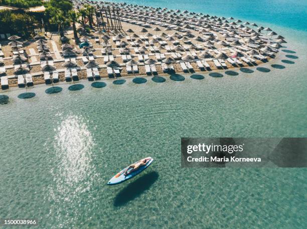 woman sunbathing on stand up paddle board view from above. - oludeniz imagens e fotografias de stock