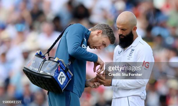 Moeen Ali of England receives medical treatment for their injured finger during Day Five of the LV= Insurance Ashes 1st Test match between England...