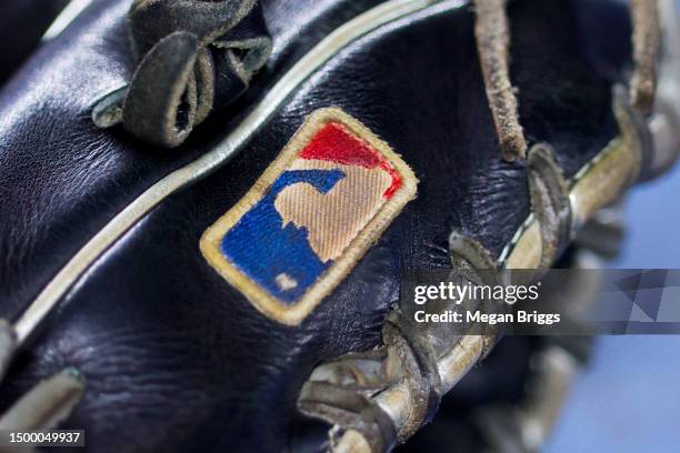 Detailed view of the MLB logo is seen on a glove prior to a game between the Toronto Blue Jays and Miami Marlins at loanDepot park on June 19, 2023...