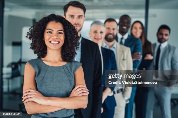 confident businesswoman and her team. - people-in-a-row stock pictures, royalty-free photos & images